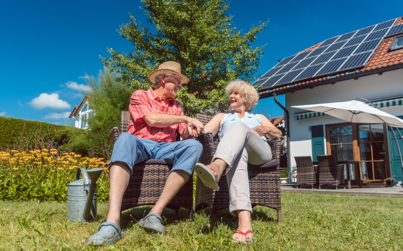 Happy senior couple in love relaxing together in the garden in a sunny day of summer Happy senior couple in love relaxing together in the garden in a sunny day of summer